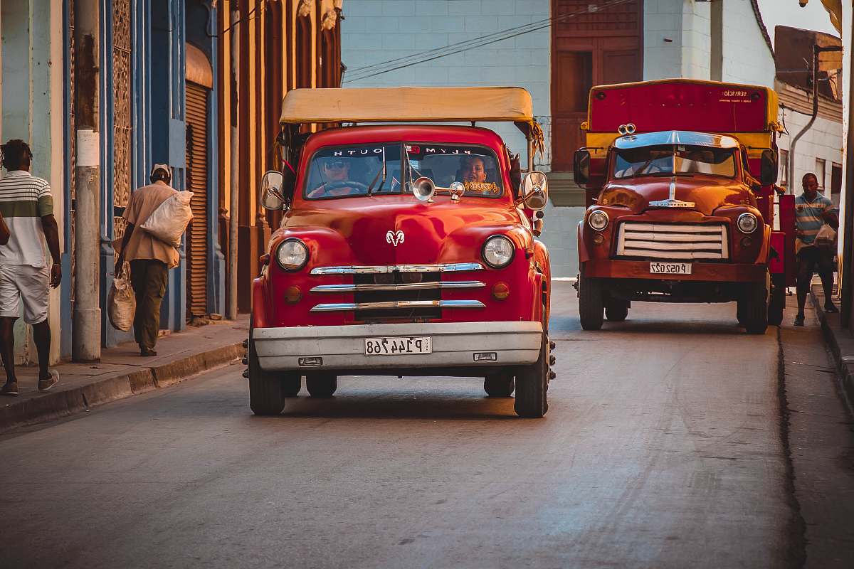 santiago de cuba red Dodge car on asphalt road during daytime cuba